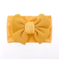 Detail of soft mustard yellow baby headband with textured fabric and large bow - Khaki/Earth Yellow