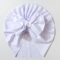 Macro detail of soft white ribbed knit baby turban with a large decorative bow - White