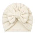Detail of baby beanie featuring wheat ear knit texture and a large cream-white bow - Beige