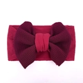 Close-up of soft burgundy baby headband with large waffle texture bow and elastic fabric - Burgundy