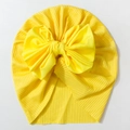 Close-up of mustard yellow ribbed knit baby turban hat with a large bow detail - Yellow