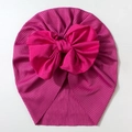 Detailed close-up of ribbed texture and large bow on vibrant rose red baby turban hat - Rose Red