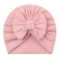 Detail of baby turban hat featuring pink striped knit fabric and a large soft bow - Snow Bud