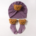 Detail of purple knitted baby headband hat and matching socks with cute brown plush bears - Deep Purple