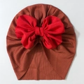 Detailed top view of soft ribbed baby turban hat with a large red bow decoration - Wine Red