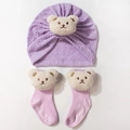 Detail of lavender knit baby hat and striped socks with fuzzy 3D bear patches - Purple