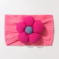 Detailed close-up of pink knitted baby headband with a large 3D fabric flower and ribbed texture - Rose Red