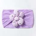 Detail of lavender baby headband with textured knit and white floral pattern flower - Purple
