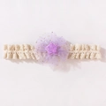 Detailed close-up of baby lace headband featuring a purple mesh flower and sequin star - Purple