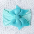 Detailed close-up of a mint green soft nylon baby headband with a large layered bow knot - Mint Green