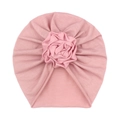 Detail of baby turban hat featuring a handcrafted soft pink rose and knitted fabric texture - Dusky Pink