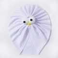 Close-up of lilac ribbed cotton baby hat with cute cartoon plush eyes and yellow beak - White