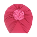 Close-up of deep pink baby turban with detailed satin rose flower embellishment - Rose Red