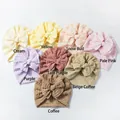 Detailed flat lay of eight soft pleated baby beanies with large matching decorative bows - 8 Colors Mixed