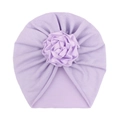 Detail view of a soft lavender infant turban hat with a large handmade floral rose decoration - Purple