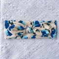 Detailed close-up of ribbed fabric baby headband with blue floral print and bow knot - Off-white Blue Floral (B)
