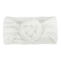 Close-up of soft white knitted baby headband with elastic nylon and a large pom-pom knot - White