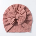 Detail of baby turban hat featuring a large bow and soft ribbed texture in Morandi pink - Taro Purple