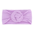 Close-up of soft lavender nylon headband with braided texture and donut knot detail - Purple
