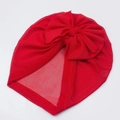 Detail of red mesh baby turban hat with a large bow showing soft breathable texture - Red