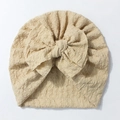 Detailed view of soft cream baby turban hat with ribbed texture and large bow decoration - Beige Coffee