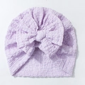 Detailed close-up of light purple baby turban hat featuring a large soft bow and bubble texture - Purple