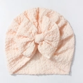 Detailed texture of peach bubble crepe baby turban hat with oversized soft fabric bow - Snow Bud
