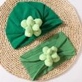 Detail view of baby turban and headband set featuring 3D sewn flower ornaments - Green
