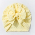 Detail of baby turban hat showing soft yellow seersucker fabric and large decorative bow - Yellow