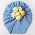 Detail of baby turban hat with sky blue waffle fabric and yellow floral daisy decoration - Blue