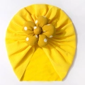 Detail of baby turban hat showing yellow seersucker fabric and large polka dot flower - Yellow