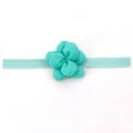 Détail d'un bandeau élastique vert menthe pour bébé avec fleur en tissu 3D sur carte - Vert Menthe