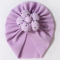 Detail view of lavender waffle knit baby turban hat with large 3D floral decoration - Purple