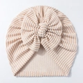 Detailed view of striped newborn hat featuring a large soft waffle knit bow detail - Beige Coffee