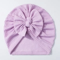 Detailed view of lavender newborn ribbed hat with a large bow showing soft knit texture - Purple