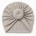 Detail of grey cable knit baby donut hat featuring a soft twisted knot design - Gray