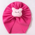Detail view of pink baby turban with waffle texture and plush pig ornament - Rose Red