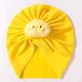 Detailed view of yellow baby turban hat with cute plush chick decor and waffle texture - Yellow