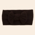 Close-up of deep brown waffle knit baby headband with a large decorative soft bow - Black