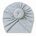 Close-up detail of soft light blue baby turban hat with donut knot and ribbed texture - Blue