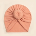 Detail of soft peach baby turban hat featuring a donut knot and fine knit texture - Orange