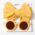 Detail of baby yellow headwrap with cable knit texture and matching round sunglasses set - Earthy Yellow