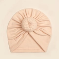 Detail of soft peach donut baby turban with center pleated knot and smooth edge stitching - Nude Pink