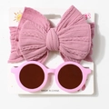 Detailed view of pink knitted bow headband and round sunglasses on a display card - Taro Purple