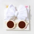 Detail of white knit bow headband and beige round baby sunglasses on display card - White