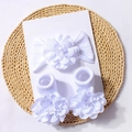 Detailed macro view of white baby floral headband and sock set with handmade flowers - White