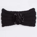 Detailed close-up of a black knitted winter headband for babies with a large floral decoration - Black