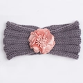 Detail of grey knitted baby headband with decorative pink fabric flower embellishment - Gray