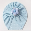 Detail of light blue eyelet baby beanie with a purple 3D fabric flower and daisy patches - Blue