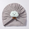 Close-up of light purple waffle knit baby hat with a white plush cloud smile applique - Gray